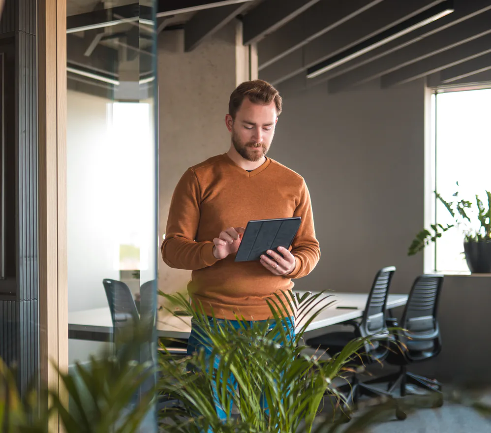 A team member configuring an AI agent on a tablet in an office