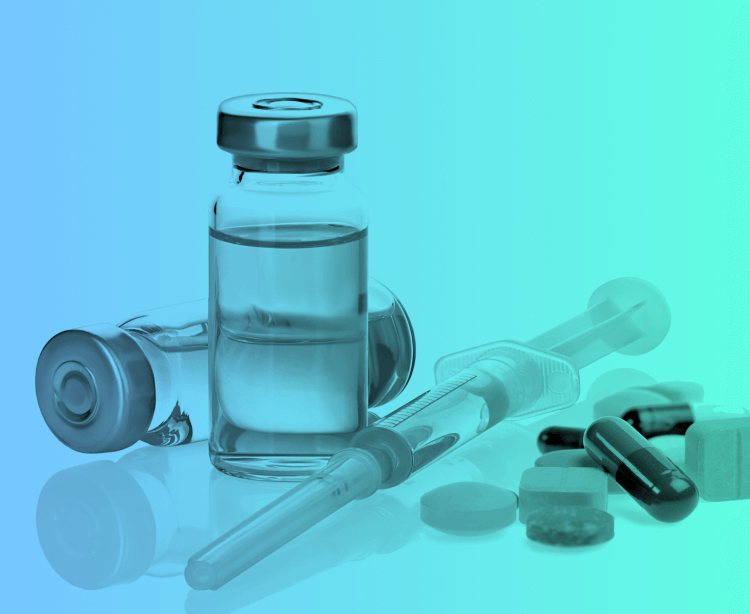 A grouping of medications including a vial, syringe, and pills