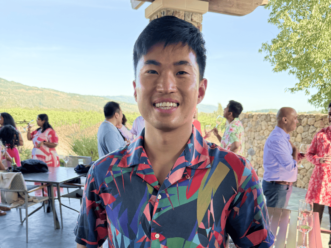 A colleague smiling at an outdoor company gathering
