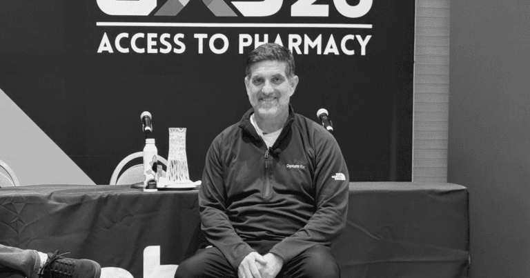 Optum Rx CIO Santiago Abraham appears on stage at Asembia's AXS26 in this black-and-white photo.